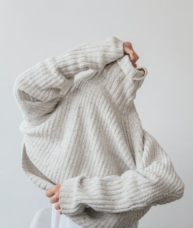 image of person wearing gray knit sweater